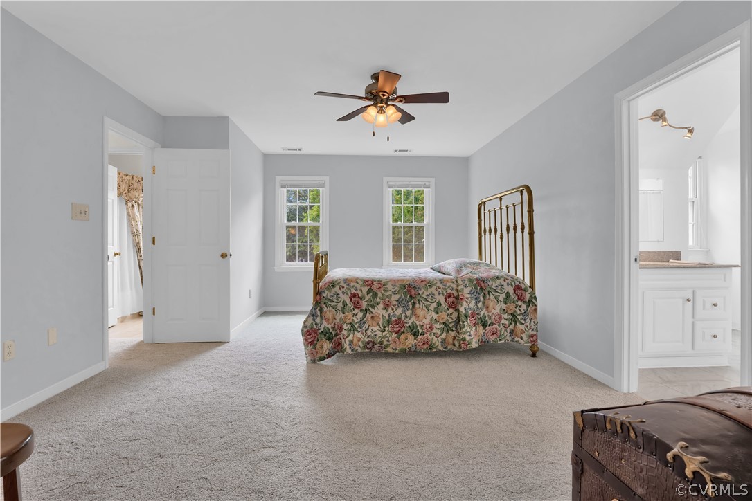7531 Genuine Risk Lane Midlothian, VA 23112 - Photo 27 of 50 a bedroom with a large bed and a chandelier
