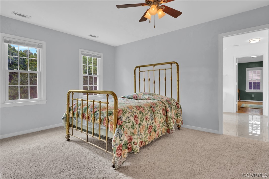 7531 Genuine Risk Lane Midlothian, VA 23112 - Photo 28 of 50 a bed sitting in a bedroom next to a window