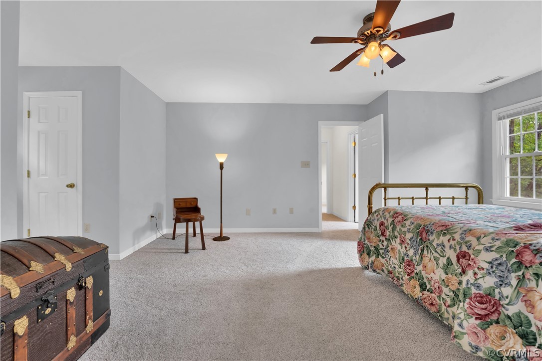 7531 Genuine Risk Lane Midlothian, VA 23112 - Photo 29 of 50 a bed room with a bed and a chandelier
