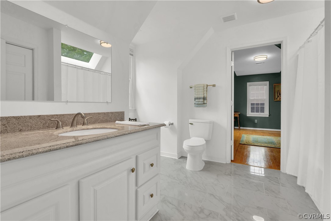 7531 Genuine Risk Lane Midlothian, VA 23112 - Photo 30 of 50 a bathroom with a granite countertop sink toilet and shower