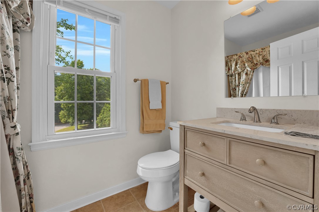 7531 Genuine Risk Lane Midlothian, VA 23112 - Photo 37 of 50 a bathroom with a granite countertop toilet sink and mirror