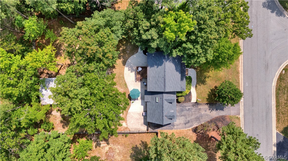 7531 Genuine Risk Lane Midlothian, VA 23112 - Photo 47 of 50 a front view of a house with a yard garage and outdoor seating