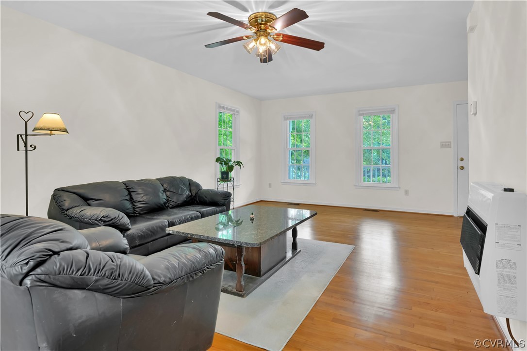 7531 Genuine Risk Lane Midlothian, VA 23112 - Photo 8 of 50 a living room with furniture and a wooden floor