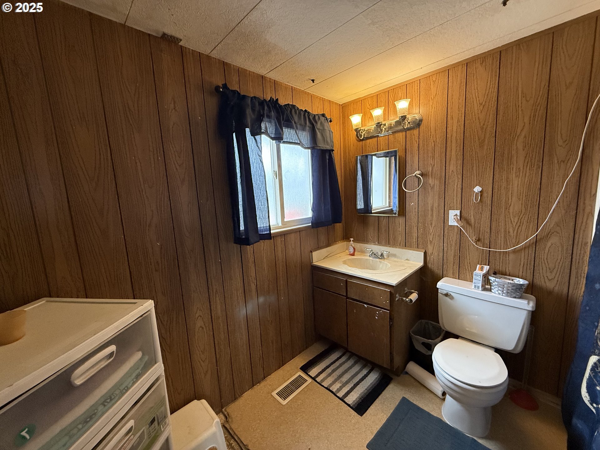 260 North 13th Street Elgin, OR 97827 - Photo 12 of 13 a bathroom with a sink toilet mirror vanity and shower