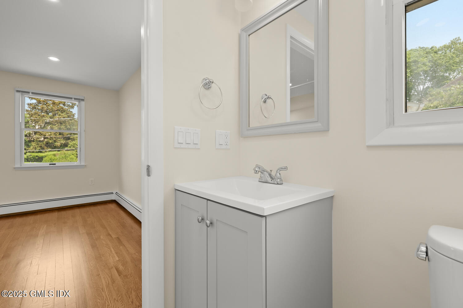 248 Byram Road, Unit L Greenwich, CT 06830 - Photo 12 of 17 a bathroom with a sink a mirror and a window