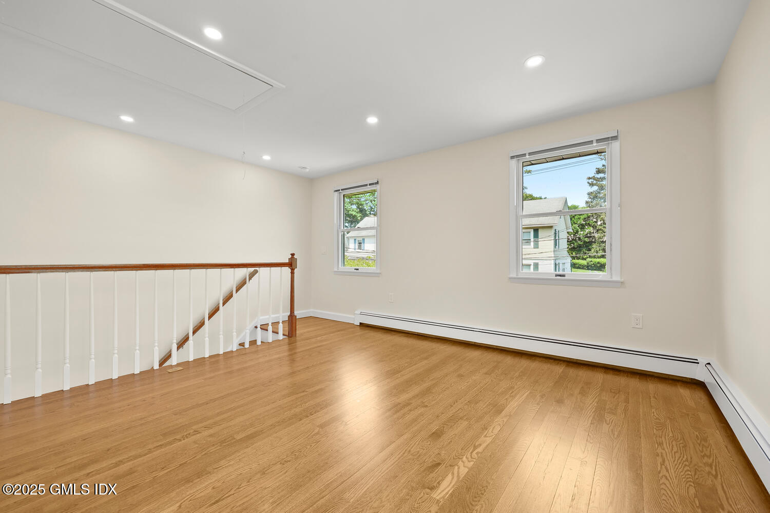 248 Byram Road, Unit L Greenwich, CT 06830 - Photo 8 of 17 a view of an empty room with wooden floor and stairs