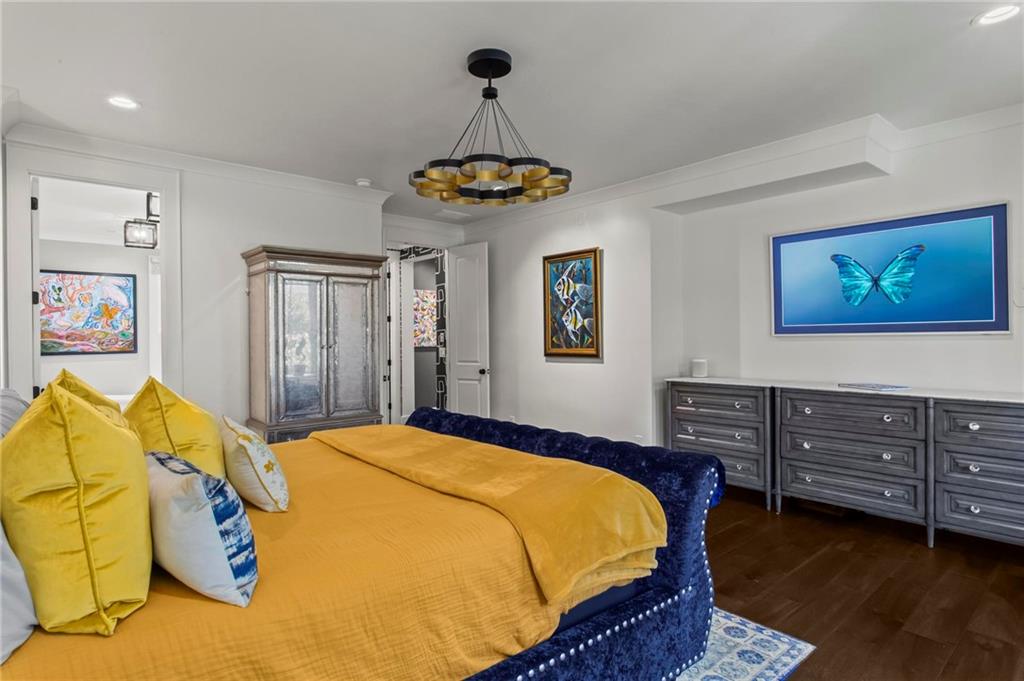 53 Maple Street Roswell, GA 30075 - Photo 16 of 59 a bedroom with a bed and a chandelier