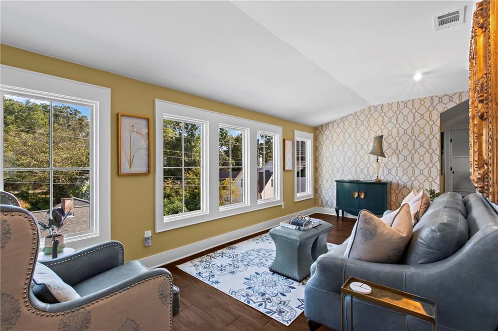 53 Maple Street Roswell, GA 30075 - Photo 26 of 59 a living room with furniture and a fireplace