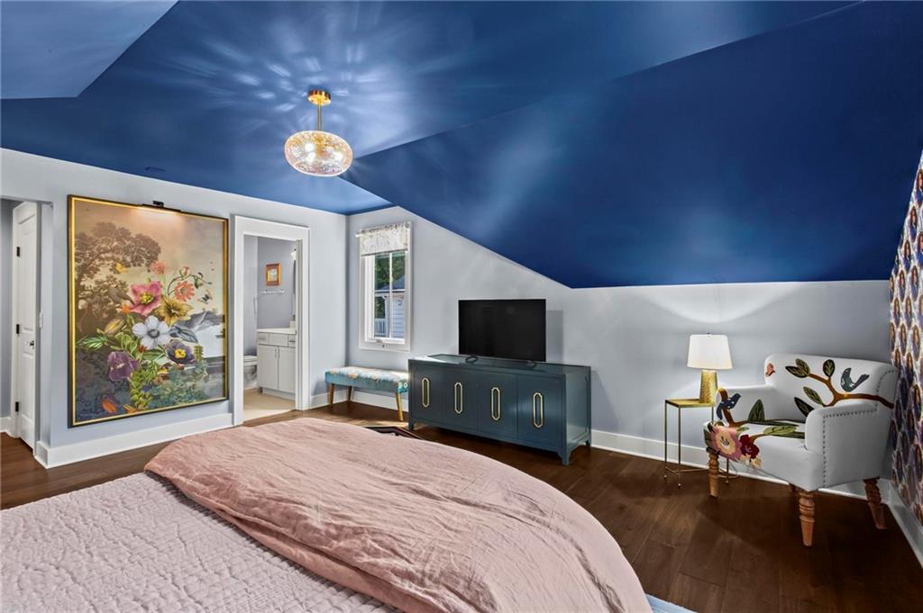 53 Maple Street Roswell, GA 30075 - Photo 31 of 59 a bedroom with a bed and a flat tv screen on dresser