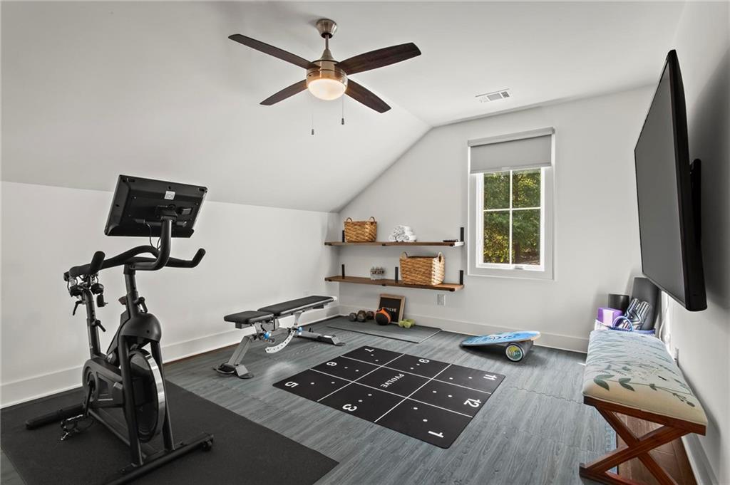 53 Maple Street Roswell, GA 30075 - Photo 34 of 59 a room with furniture a flat screen tv and a window