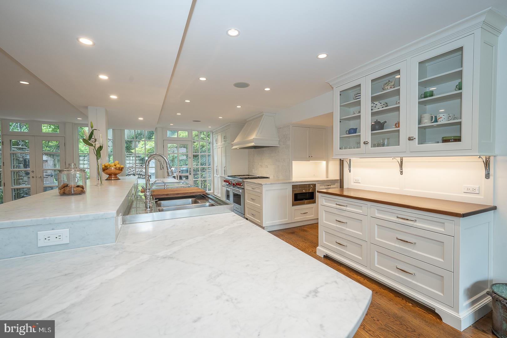 15 Old Gulph Road Gladwyne, PA 19035 - Photo 11 of 66 a large kitchen with kitchen island a large counter top stainless steel appliances and windows
