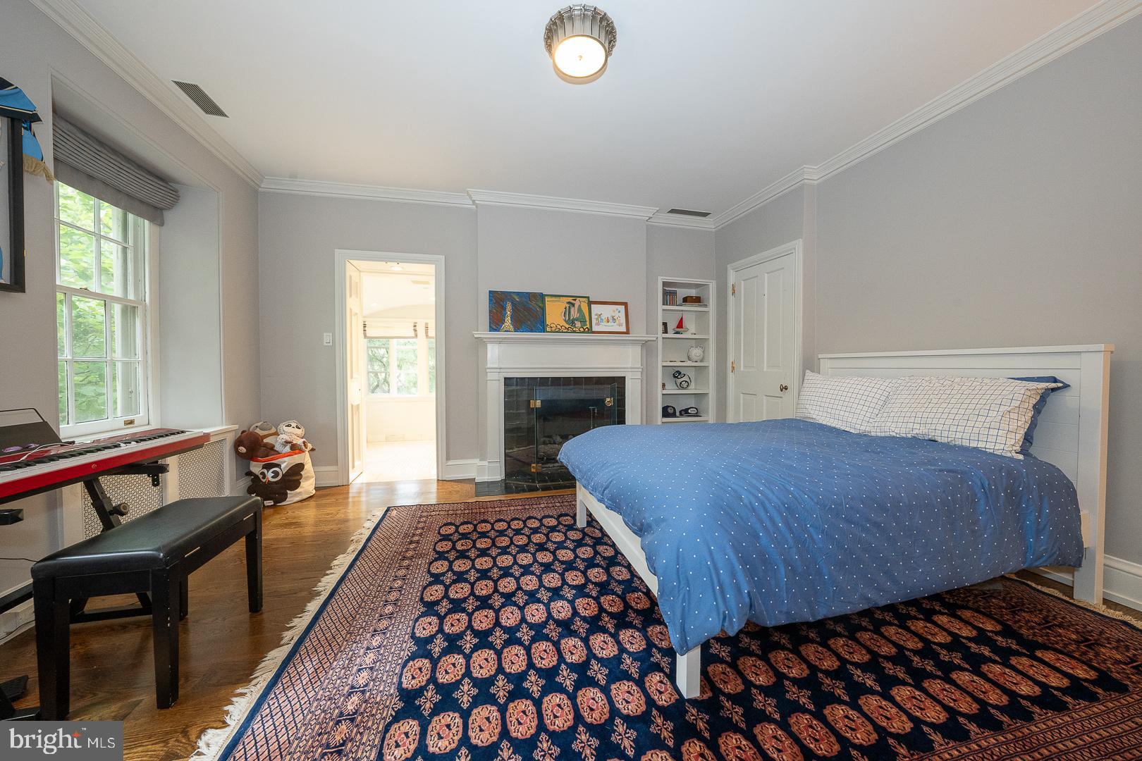 15 Old Gulph Road Gladwyne, PA 19035 - Photo 33 of 66 a bedroom with a bed and a dresser next to a window