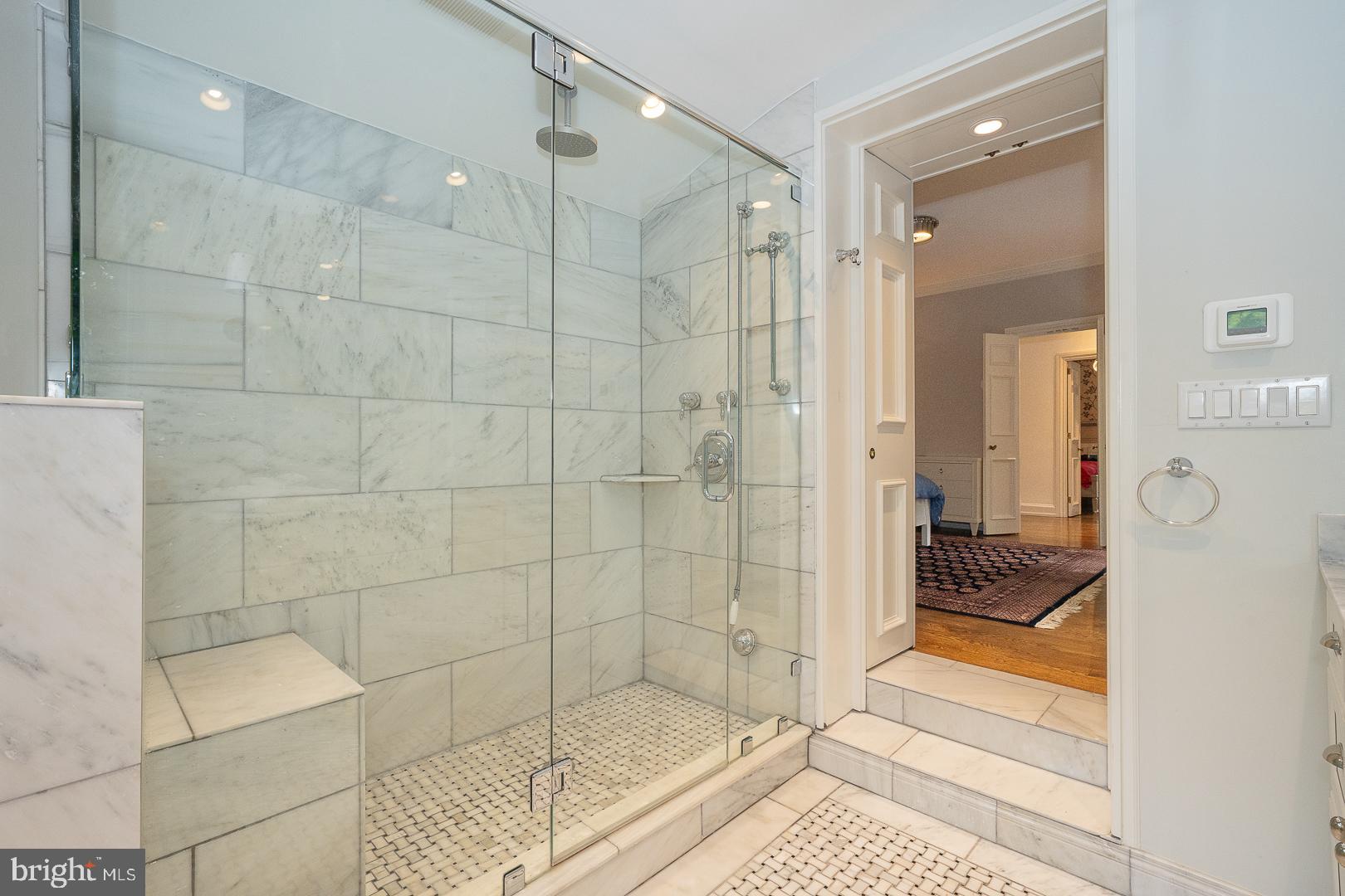 15 Old Gulph Road Gladwyne, PA 19035 - Photo 35 of 66 a bathroom with a glass shower door and a bathtub