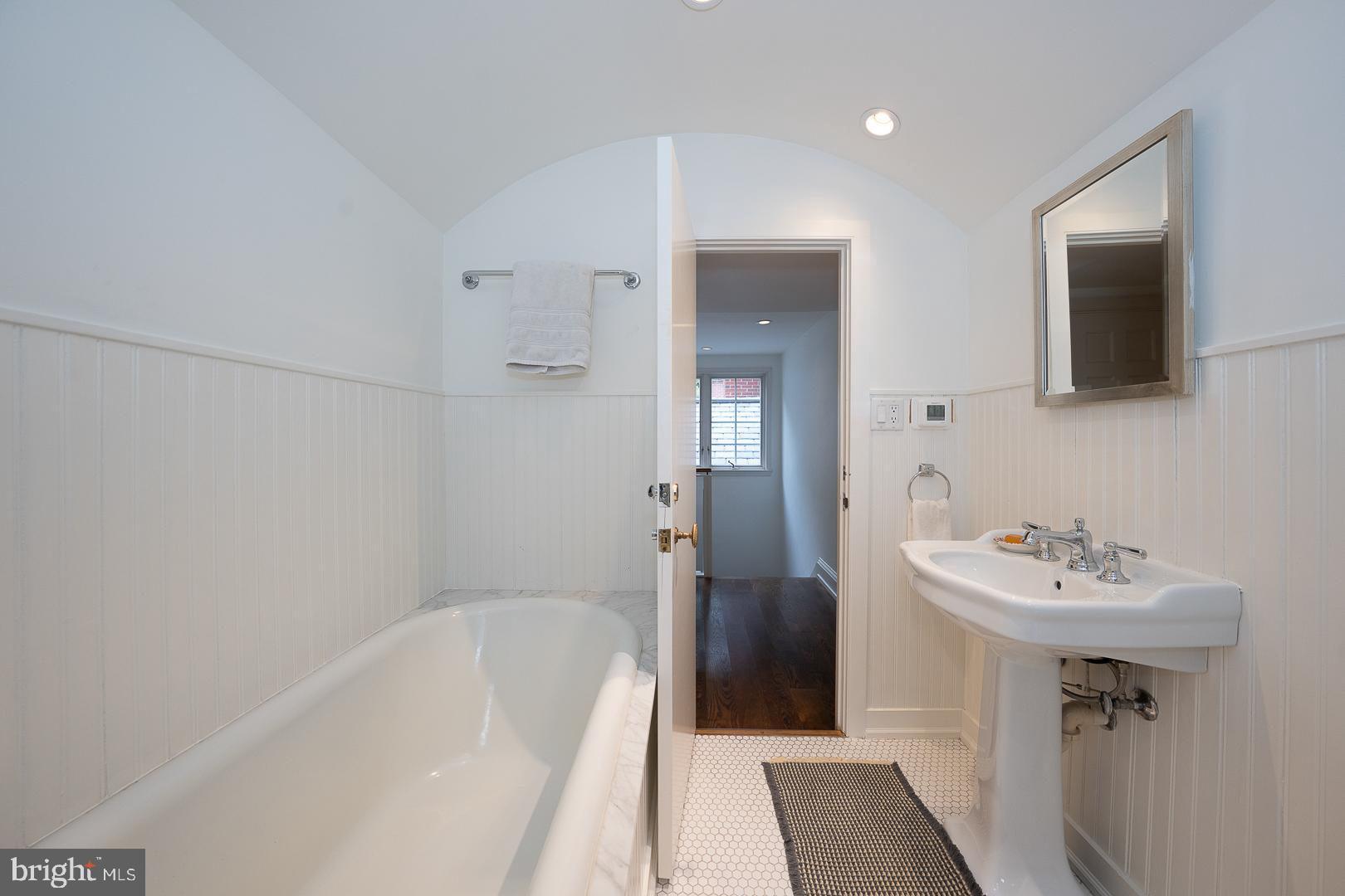 15 Old Gulph Road Gladwyne, PA 19035 - Photo 44 of 66 a bathroom with a sink a mirror and a bathtub