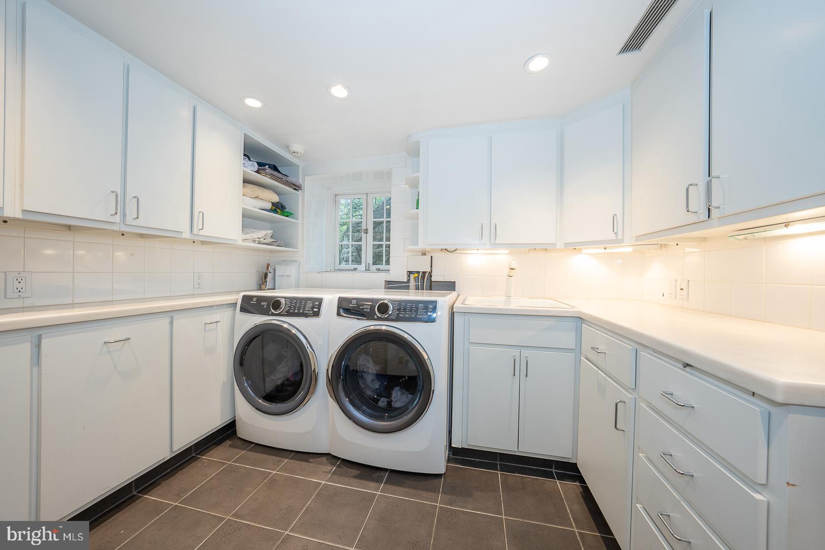 15 Old Gulph Road Gladwyne, PA 19035 - Photo 48 of 66 a utility room with sink dryer and washer