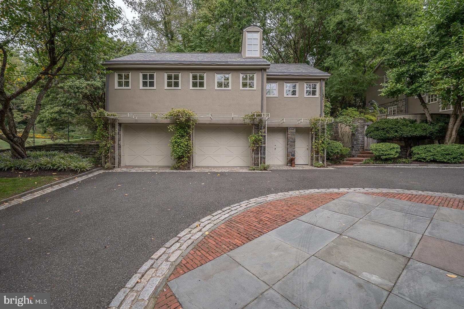 15 Old Gulph Road Gladwyne, PA 19035 - Photo 49 of 66 a front view of a house with a garden and trees