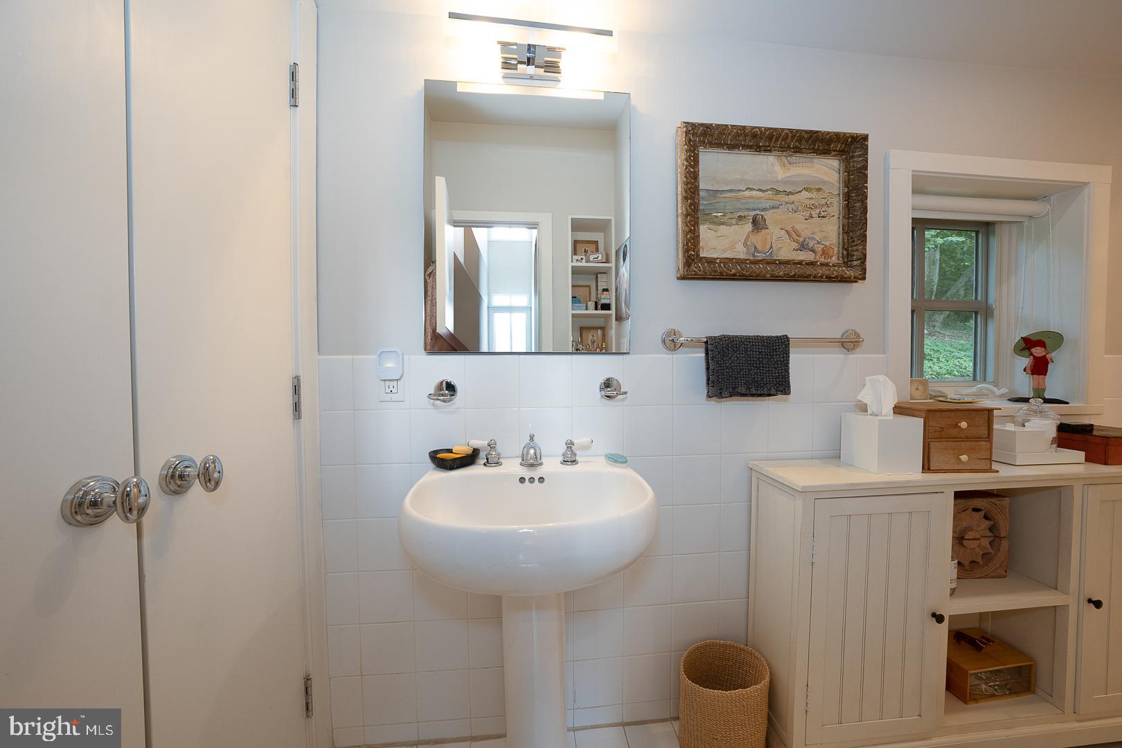 15 Old Gulph Road Gladwyne, PA 19035 - Photo 53 of 66 a bathroom with a sink a toilet and mirror