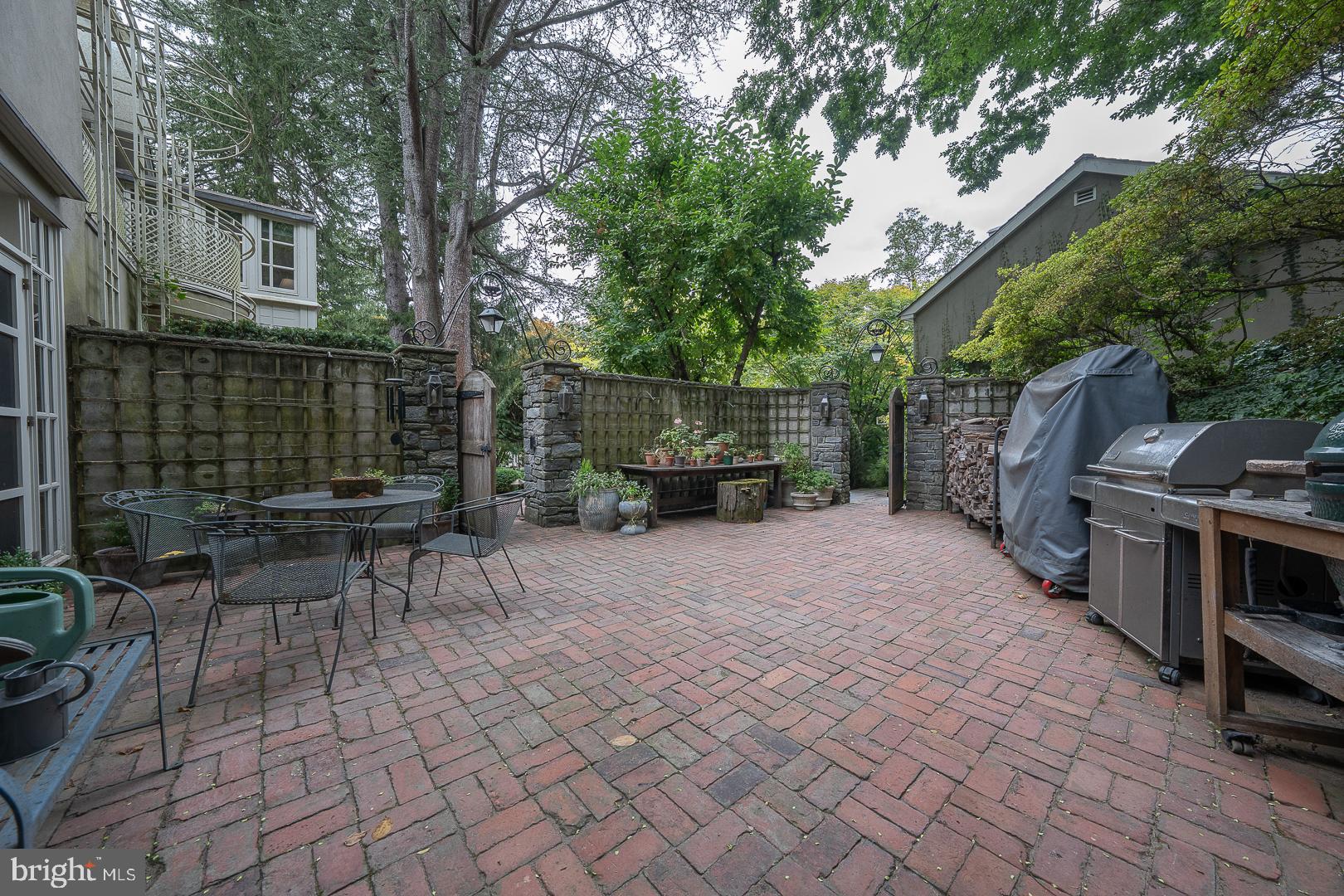 15 Old Gulph Road Gladwyne, PA 19035 - Photo 56 of 66 a view of a patio with table and chairs and potted plants
