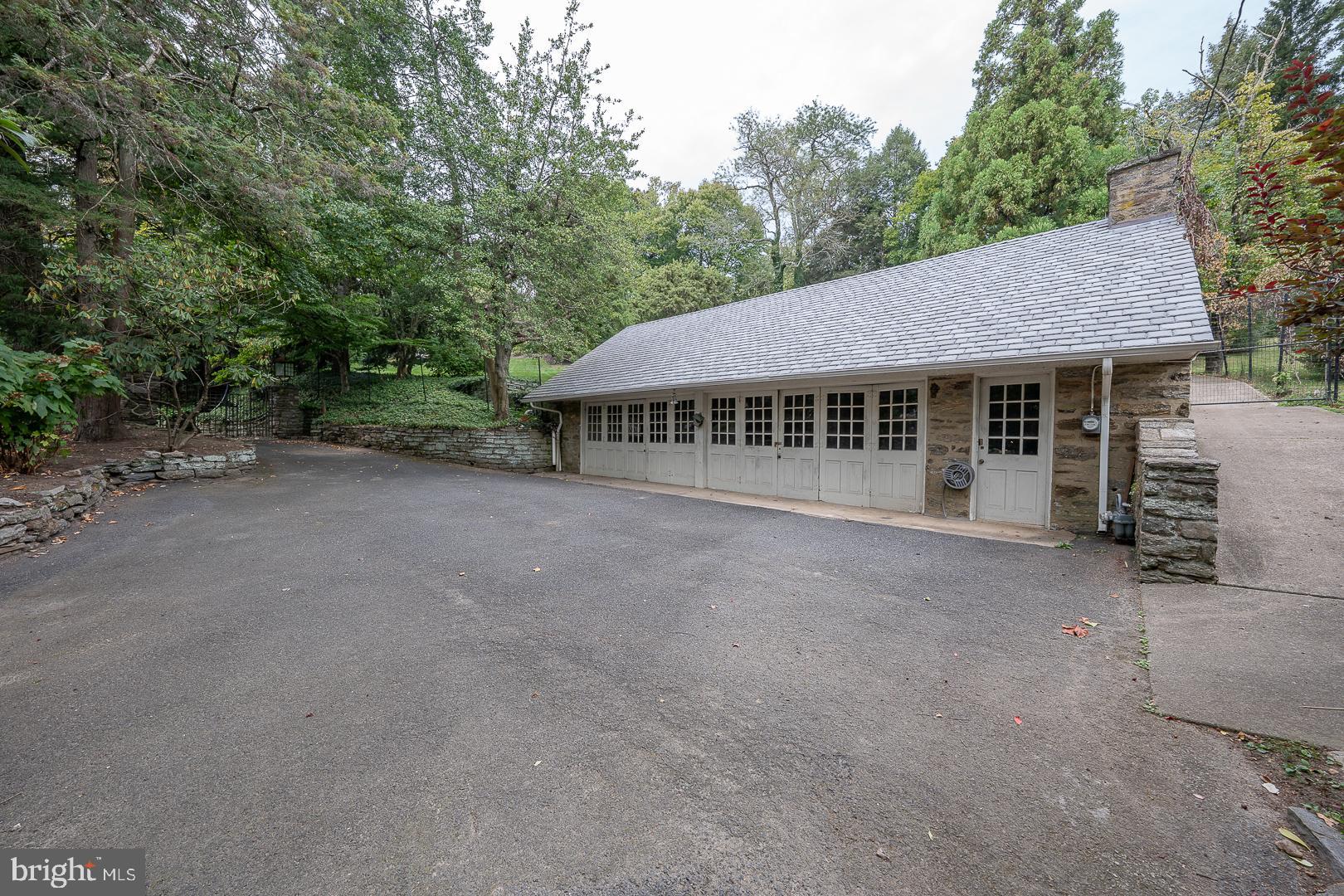 15 Old Gulph Road Gladwyne, PA 19035 - Photo 65 of 66 a view of a house with a garden and trees