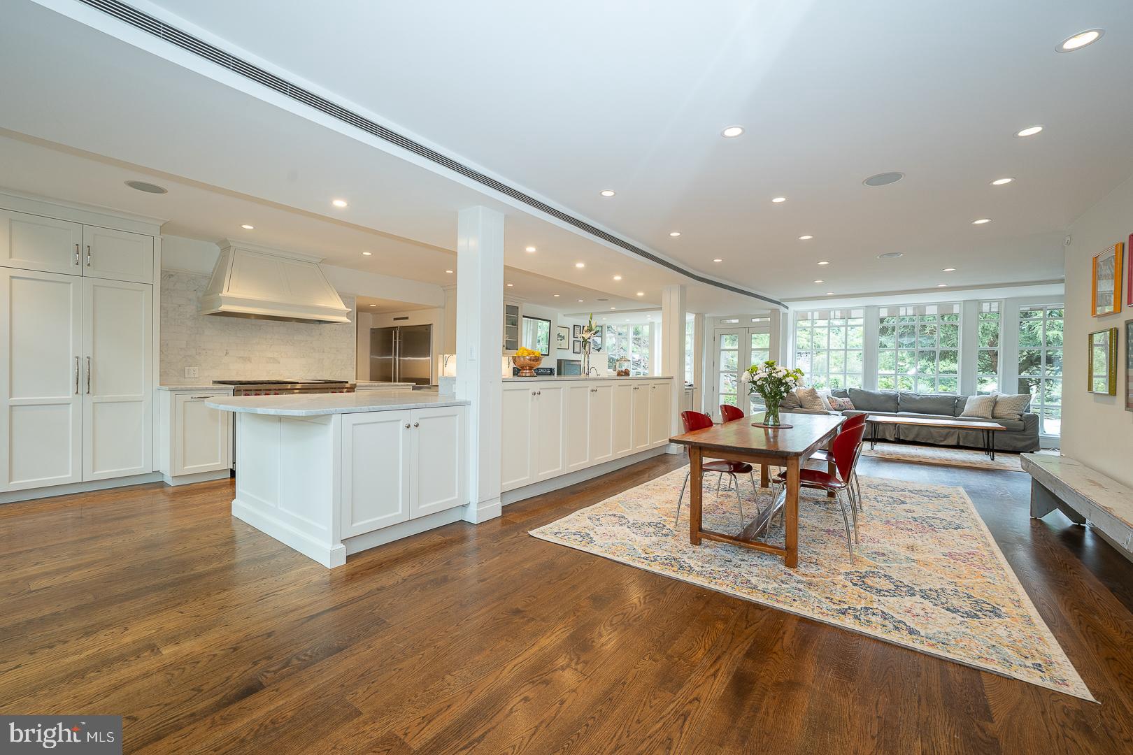 15 Old Gulph Road Gladwyne, PA 19035 - Photo 66 of 66 a kitchen with stainless steel appliances kitchen island granite countertop a refrigerator a stove a sink dishwasher with a dining table and chairs with wooden floor