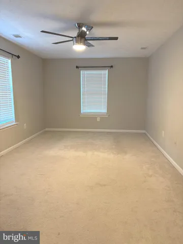 an empty room with a empty space and windows