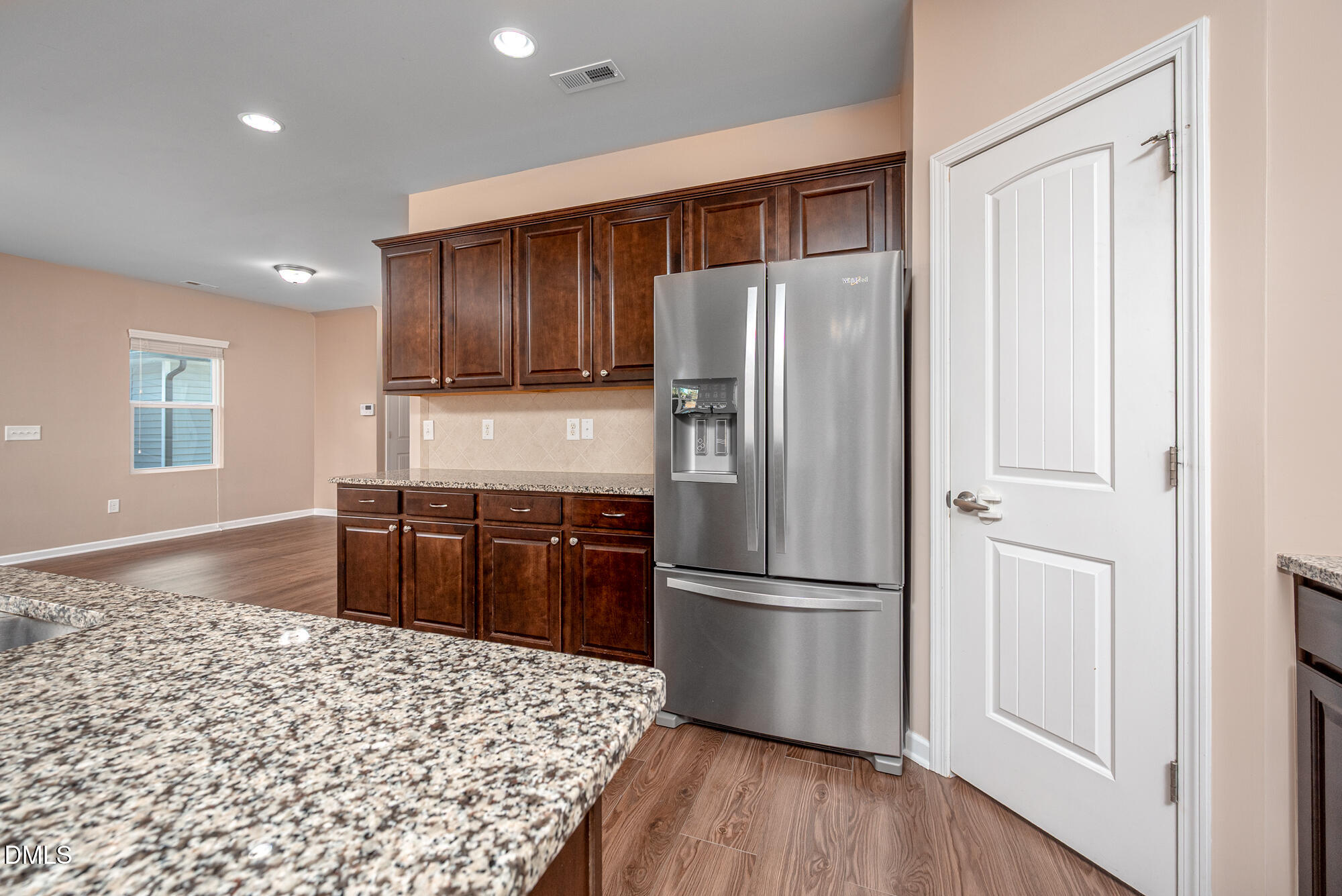 3548 Althorp Drive Raleigh, NC 27616 - Photo 15 of 56 a kitchen with a refrigerator stove and wooden cabinets