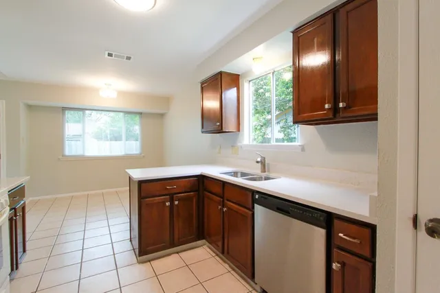 a kitchen with a sink and a window