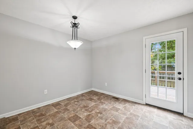 a view of a room with a ceiling fan and closet area