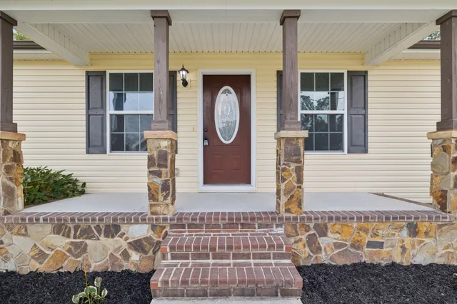 a front view of a house with garden
