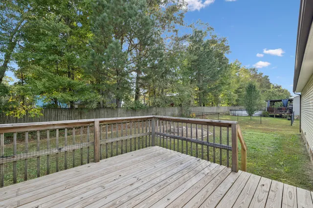 a view of a backyard with large trees