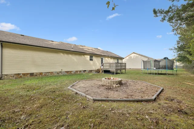 a view of a house with a yard and garage