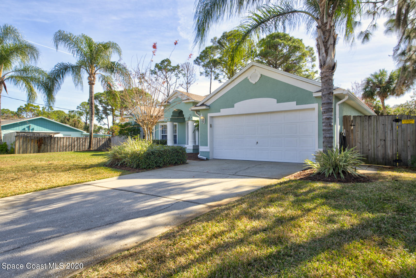 4359 Eastman Street Cocoa, FL 32927 - Photo 2 of 52 a view of a house with a yard and palm trees
