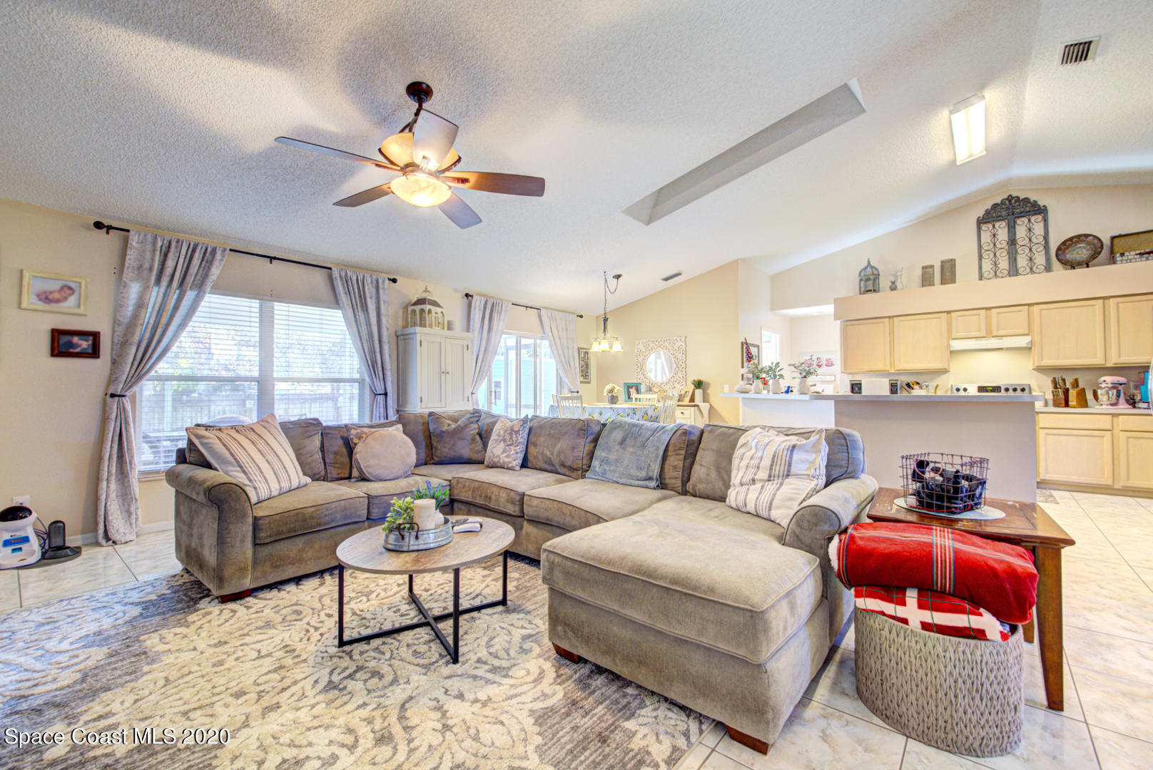 4359 Eastman Street Cocoa, FL 32927 - Photo 12 of 52 a living room with furniture a chandelier and a large window