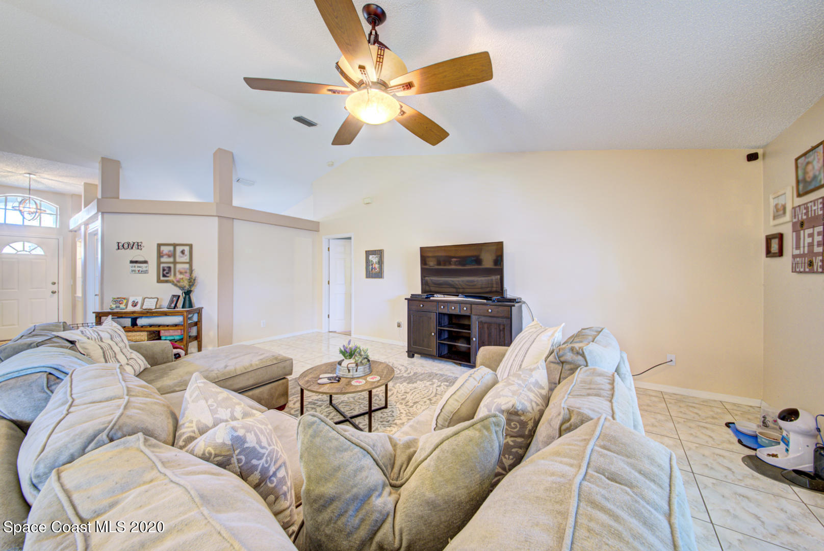 4359 Eastman Street Cocoa, FL 32927 - Photo 15 of 52 a living room with furniture a ceiling fan and a rug