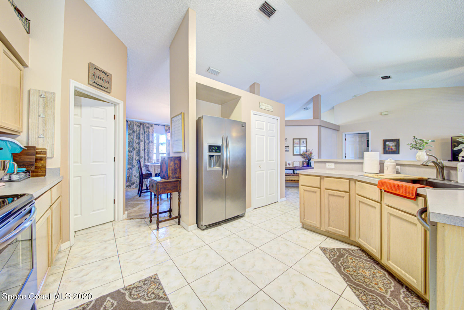 4359 Eastman Street Cocoa, FL 32927 - Photo 16 of 52 a kitchen with stainless steel appliances kitchen island granite countertop a refrigerator and a sink