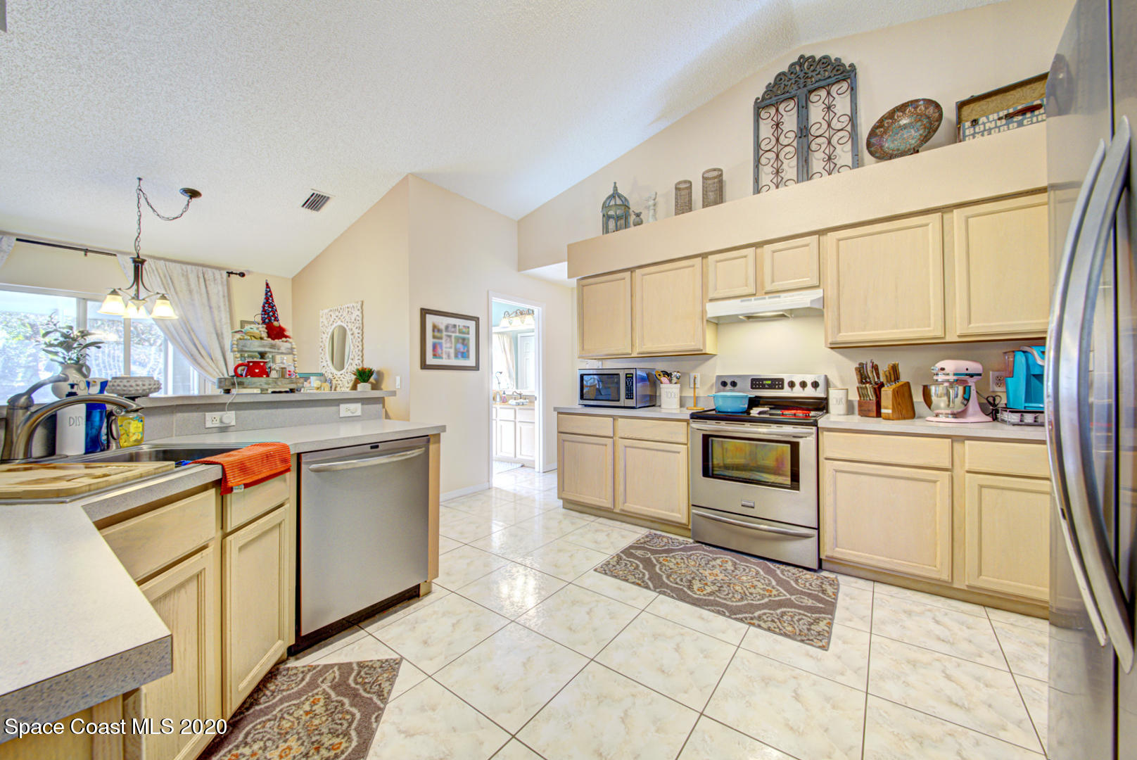 4359 Eastman Street Cocoa, FL 32927 - Photo 17 of 52 a kitchen with stainless steel appliances granite countertop a sink and cabinets