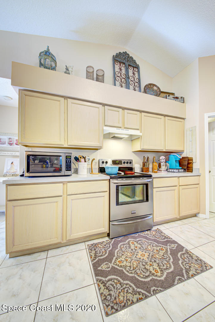 4359 Eastman Street Cocoa, FL 32927 - Photo 18 of 52 a kitchen with stainless steel appliances granite countertop a sink and cabinets