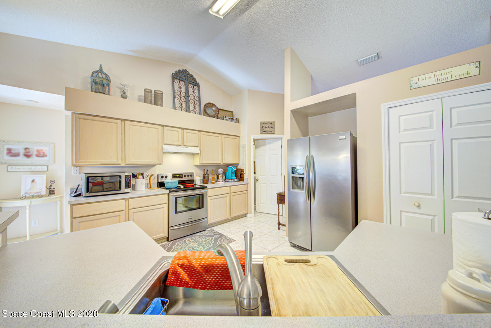 4359 Eastman Street Cocoa, FL 32927 - Photo 20 of 52 a kitchen with stainless steel appliances kitchen island granite countertop a refrigerator and a stove top oven