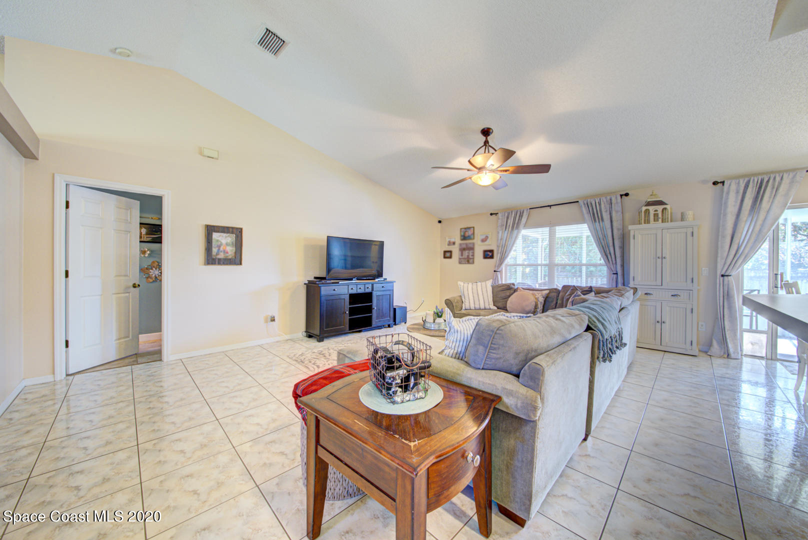 4359 Eastman Street Cocoa, FL 32927 - Photo 25 of 52 a living room with furniture a fireplace and a table
