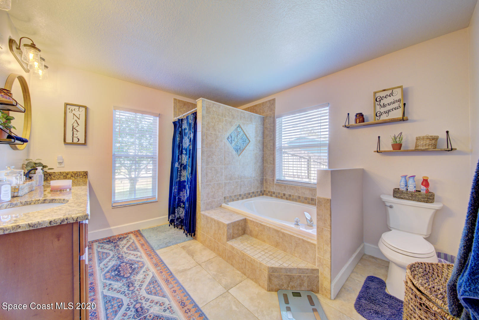 4359 Eastman Street Cocoa, FL 32927 - Photo 29 of 52 a bathroom with a granite countertop sink and a mirror
