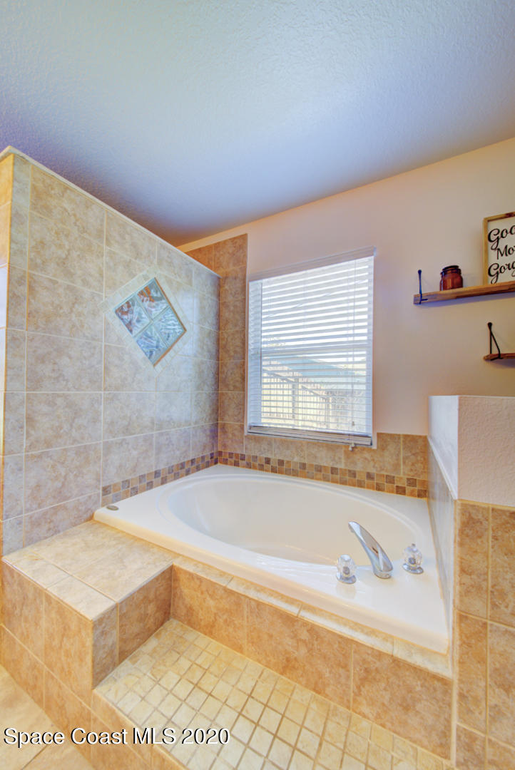 4359 Eastman Street Cocoa, FL 32927 - Photo 30 of 52 a bath tub sitting next to a bathroom sink