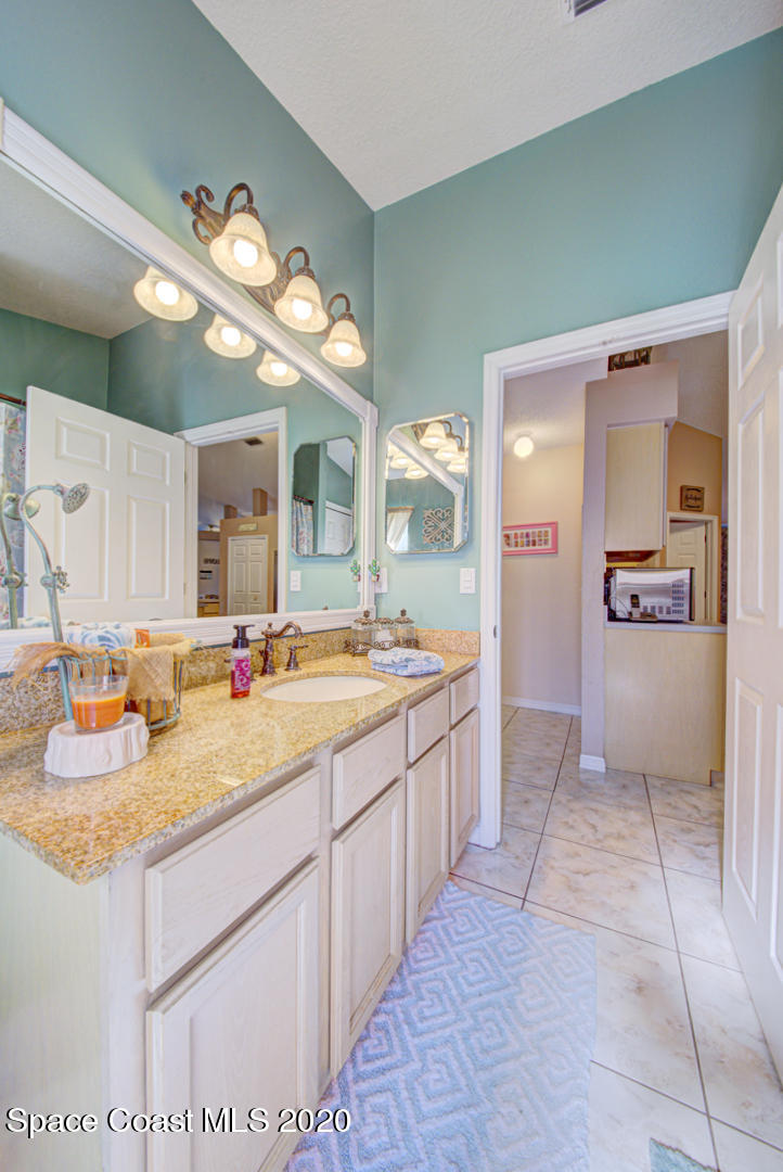 4359 Eastman Street Cocoa, FL 32927 - Photo 35 of 52 a spacious bathroom with a sink a mirror and a shower