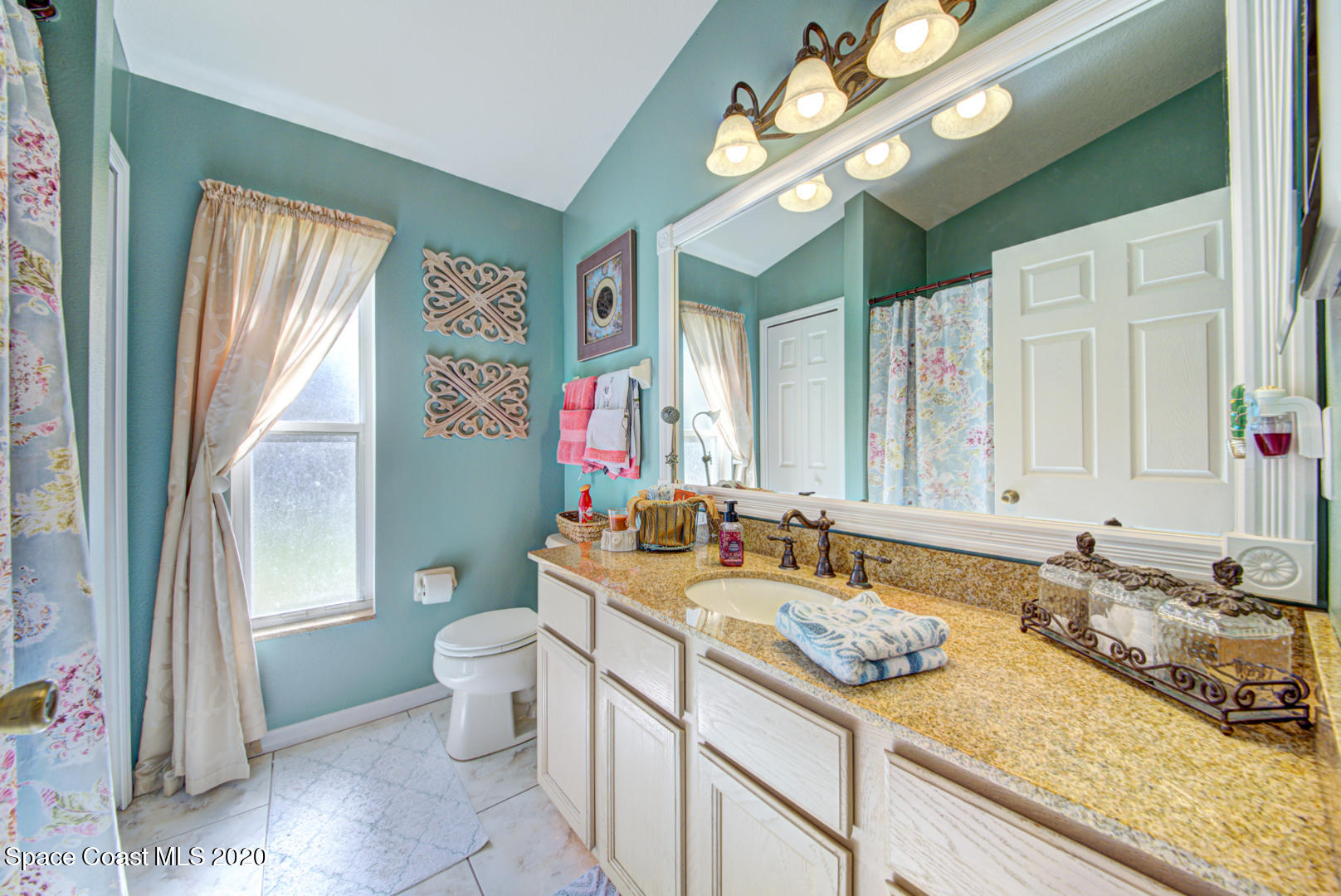 4359 Eastman Street Cocoa, FL 32927 - Photo 36 of 52 a bathroom with a granite countertop sink and a large mirror