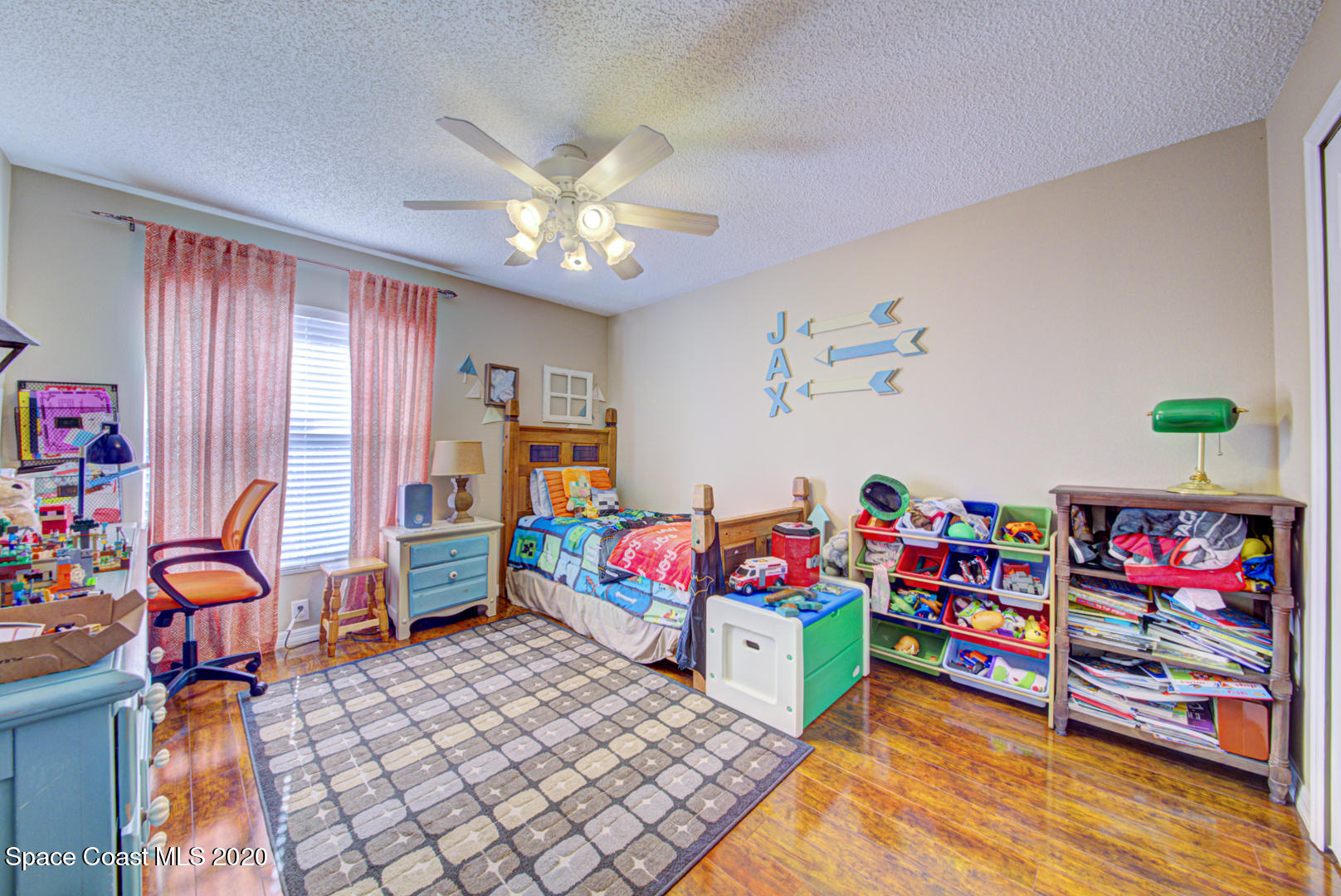 4359 Eastman Street Cocoa, FL 32927 - Photo 37 of 52 a living room with furniture toys and a baby crib