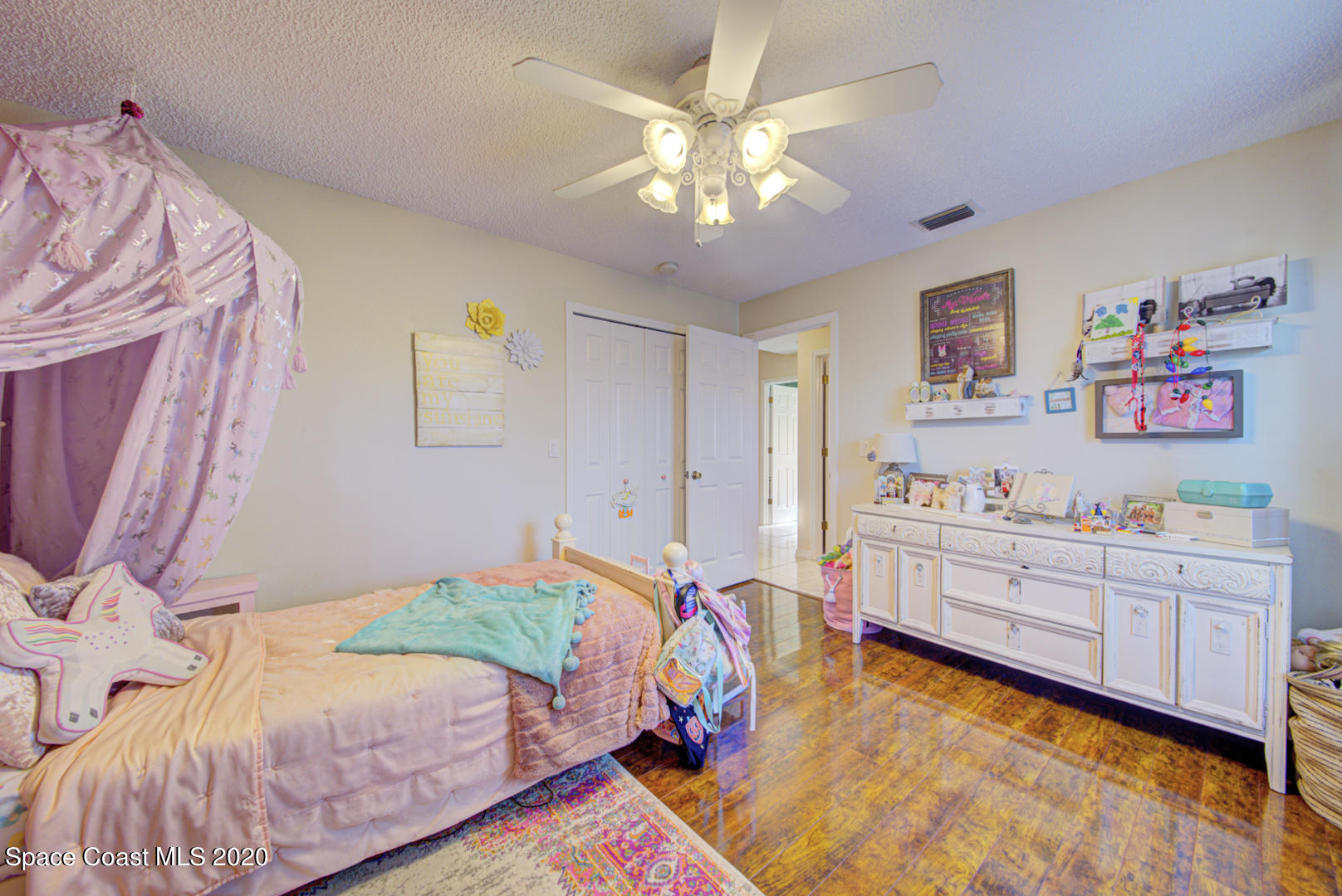 4359 Eastman Street Cocoa, FL 32927 - Photo 41 of 52 a bedroom with a bed and a chandelier