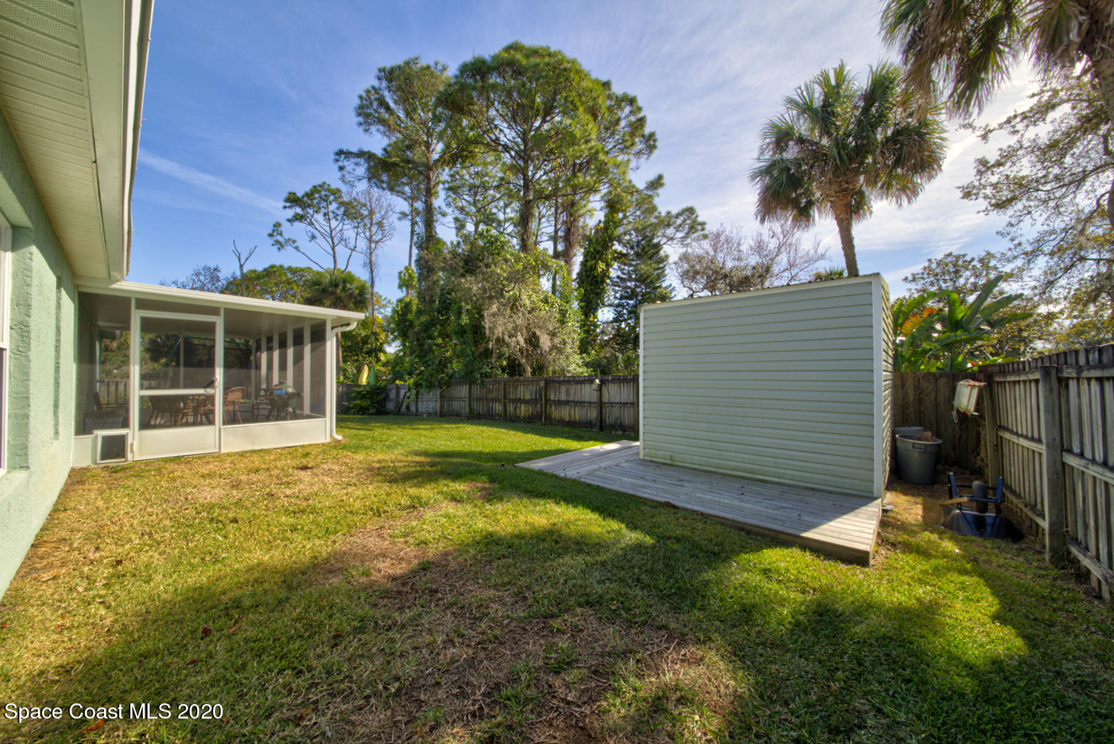 4359 Eastman Street Cocoa, FL 32927 - Photo 47 of 52 a view of a house with a backyard and a tree