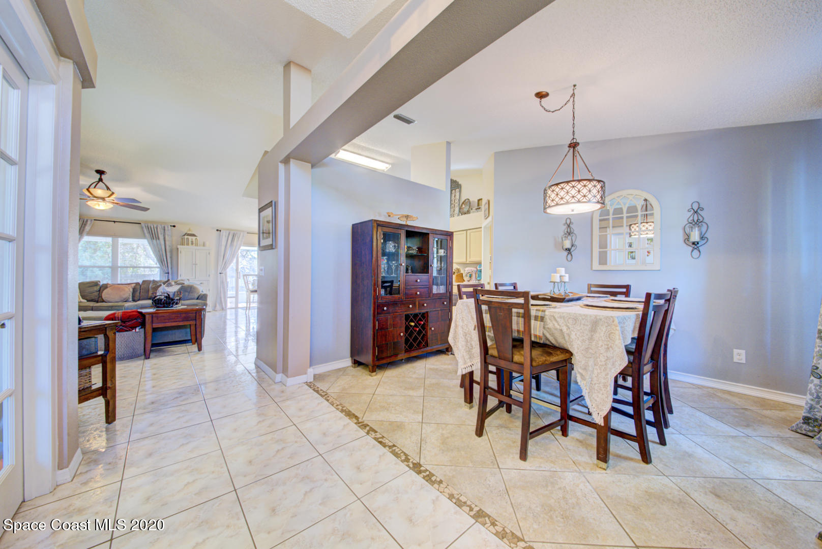 4359 Eastman Street Cocoa, FL 32927 - Photo 6 of 52 a view of a dining room and livingroom with furniture wooden floor a chandelier