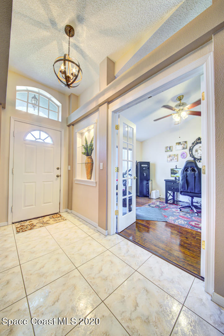 4359 Eastman Street Cocoa, FL 32927 - Photo 8 of 52 a view of a livingroom with wooden floor and kitchen view