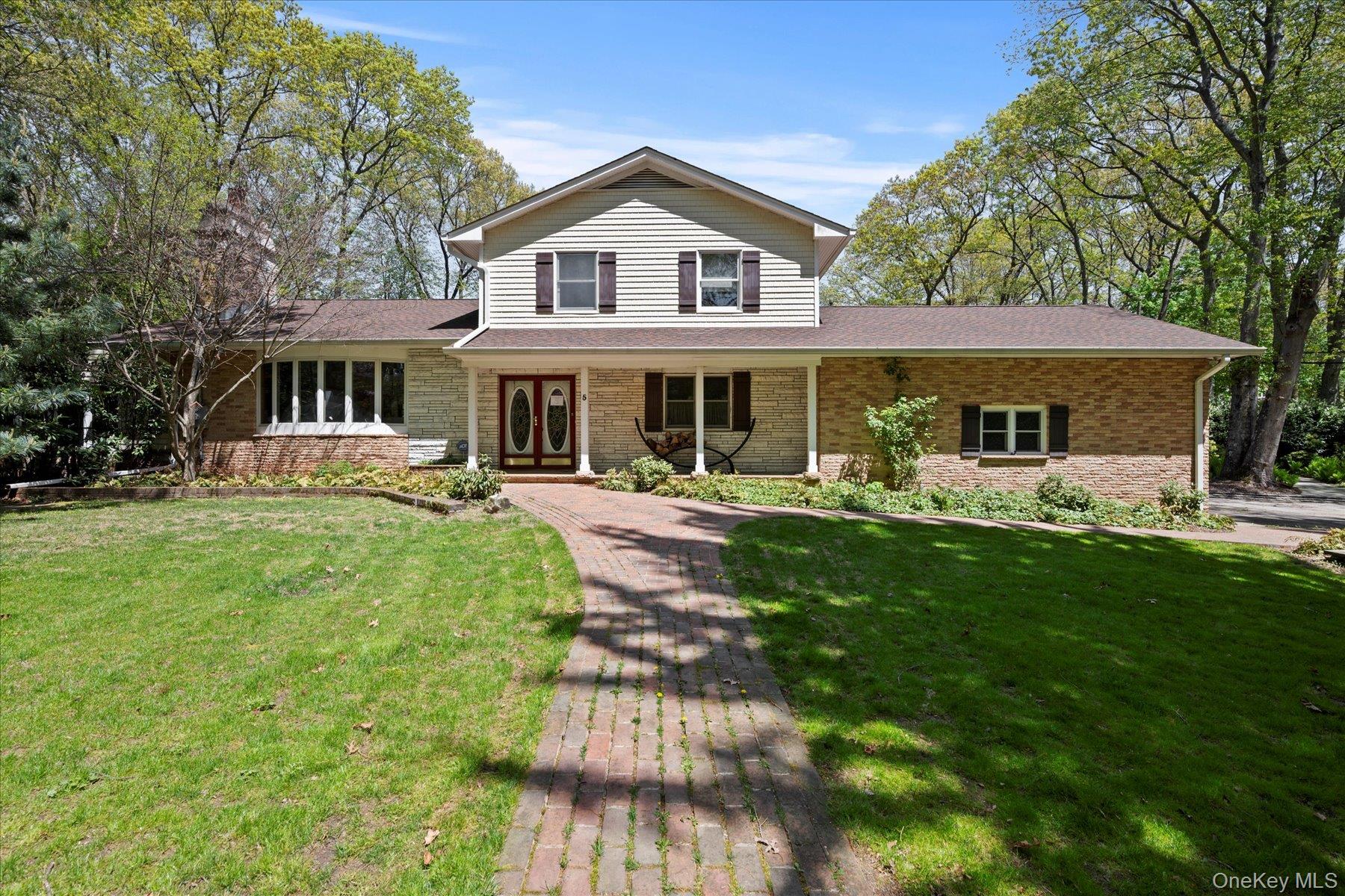 a view of a house with a yard patio and swimming pool