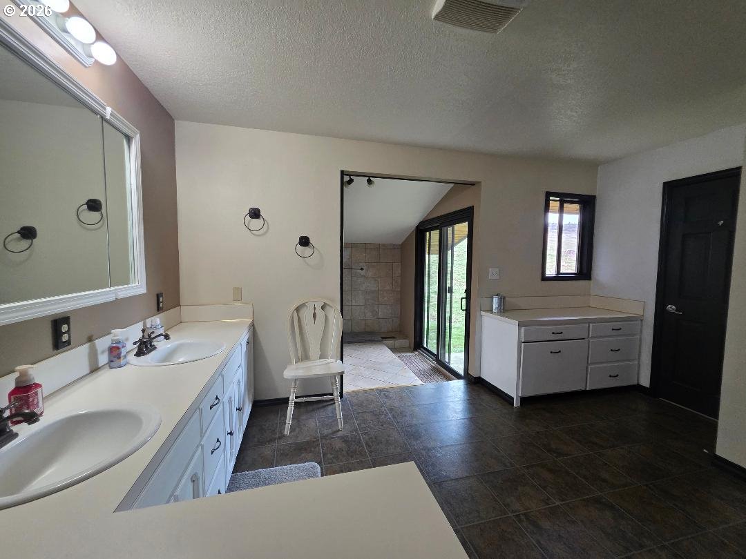 78902 Walters Road Maupin, OR 97037 - Photo 24 of 47 a en suite spacious bathroom with a double vanity sink and a mirror